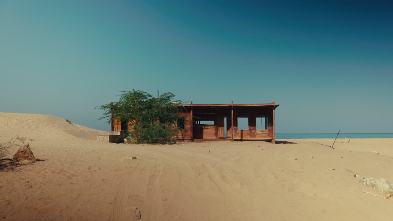 Abandoned Wooden Hut on a Desert Beach