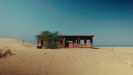 abandoned wooden hut on a desert beach