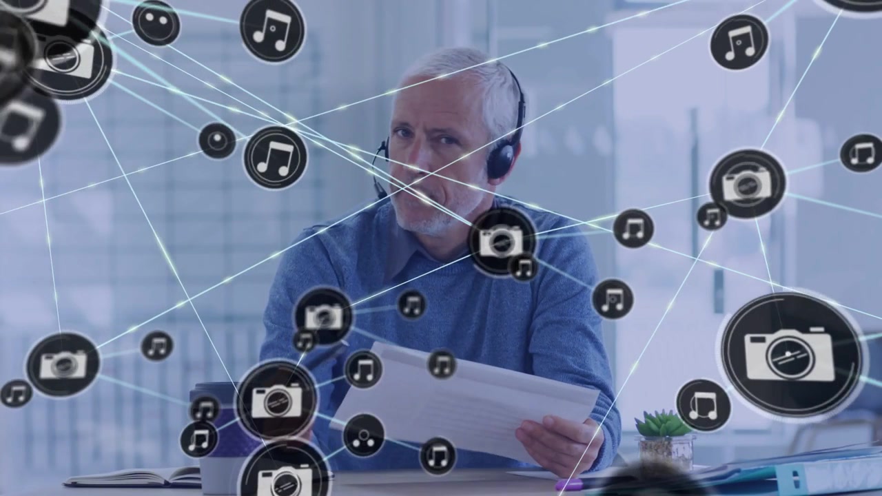 Mature Businessman in Headset Participating in Online Video Call