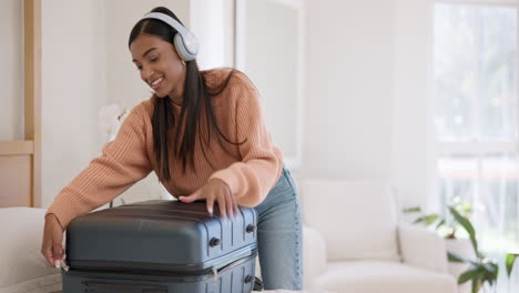 headphones, smile and woman packing luggage