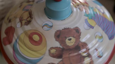 a colorful spinning toy top in motion creating a blur of vibrant patterns and colors
