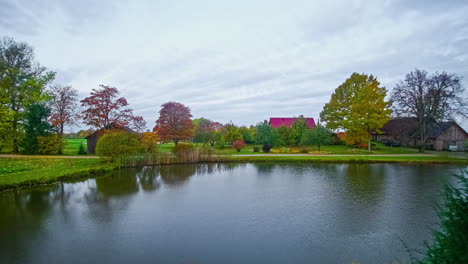 time lapse of european villlage with colorful trees and big lake or pond