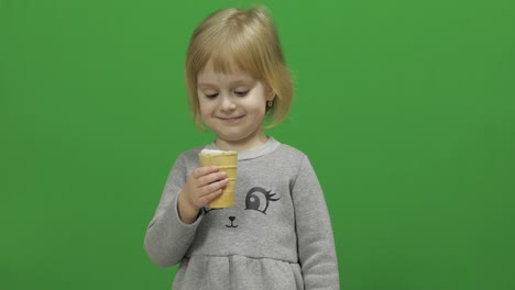 Kid-girl-eat-ice-cream-on-a-Green-Screen,-Chroma-Key