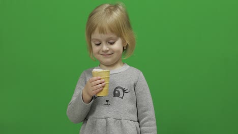 kid girl eat ice cream on a green screen, chroma key
