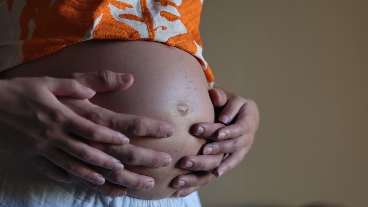 Loving Couple Holding Pregnant Baby Bump Belly - Close Up Hands SLOMO