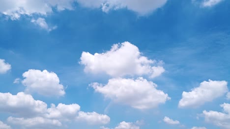White-puffy-clouds-and-blue-sky-time-lapse-with-long-second-duration-for-background-and-graphics-in-daylight