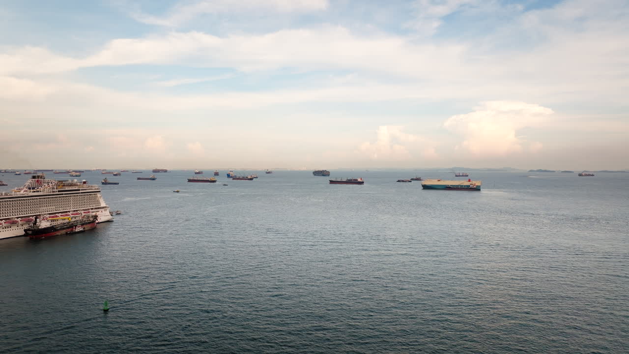 Container ships anchored in front of Singapore Port. Aerial forward and copy space