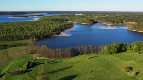 perfect lakes with blue water and lots of greenery around, aerial view