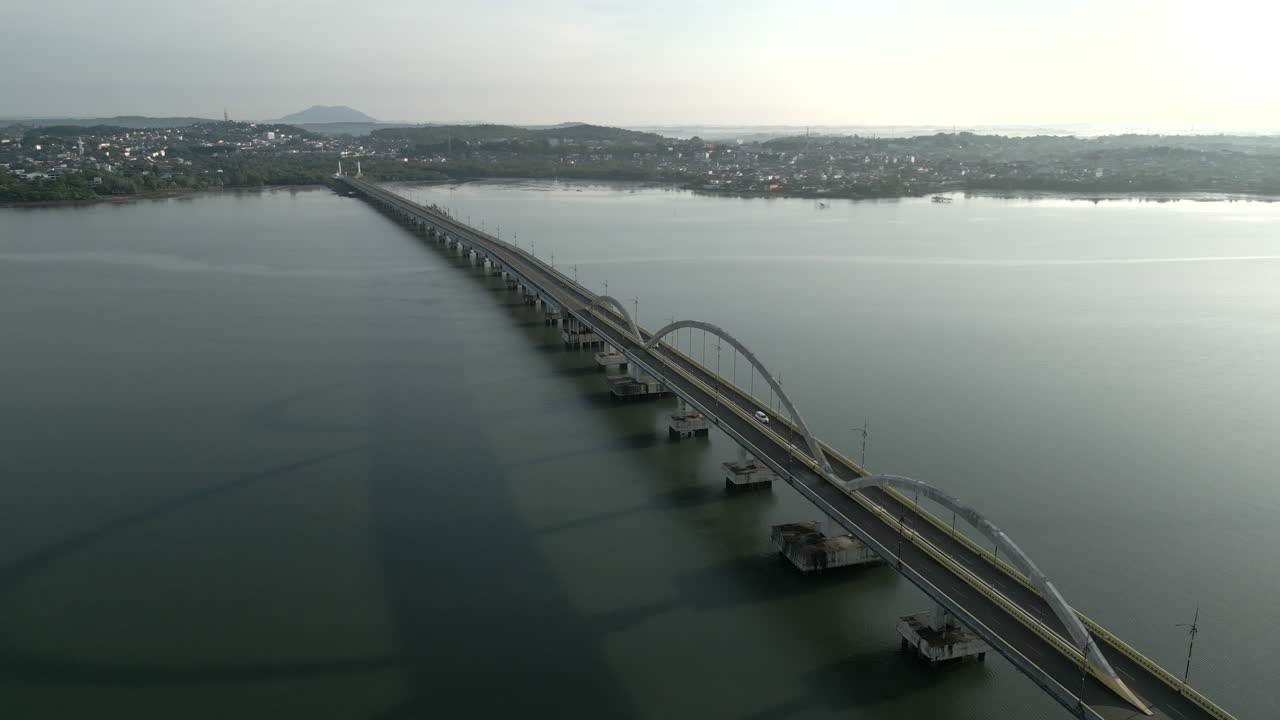 An expansive aerial view of the Dompak Bridge connecting to the city at sunrise. Located in Tanjung Pinang, Indonesia - Tanjungpinang, Indonesia