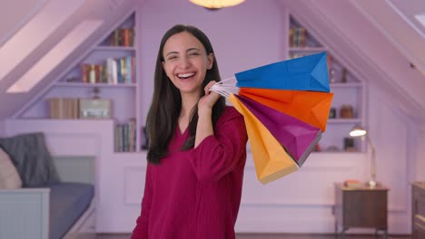 Happy-Indian-woman-posing-with-shopping-bags