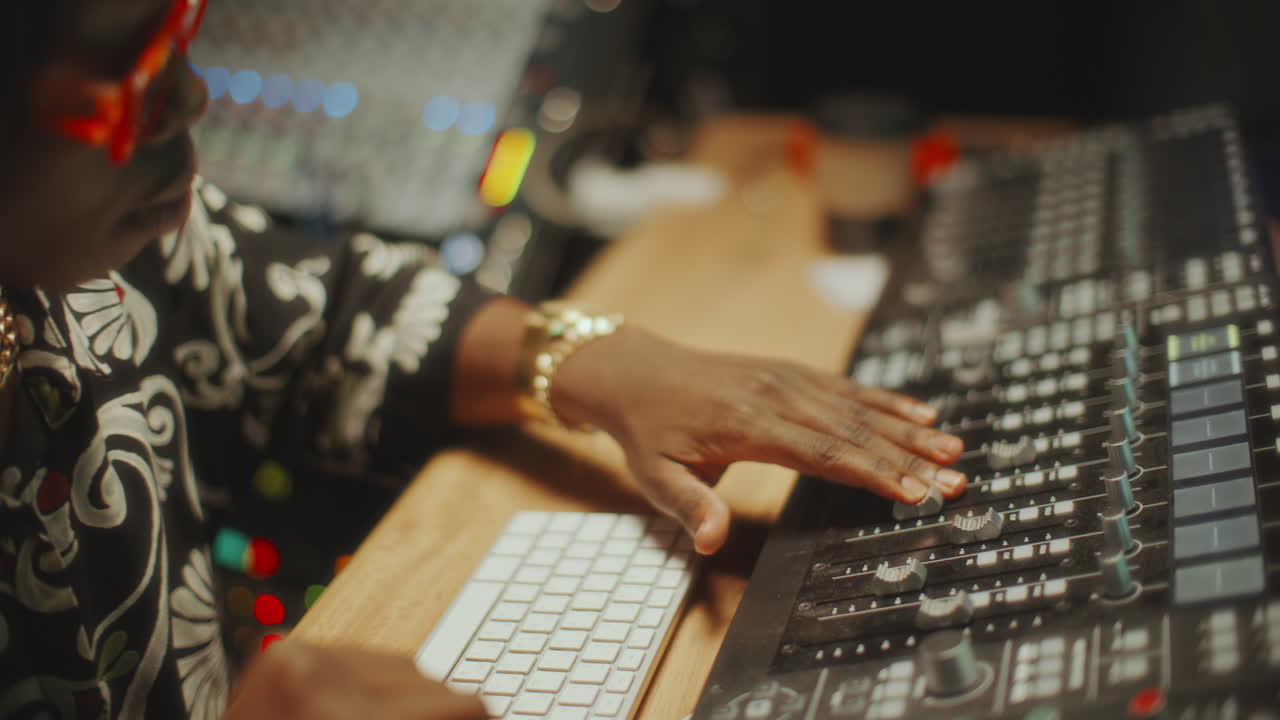 Black Sound Engineer Using Audio Mixer and Vibing to Beat in Recording Studio