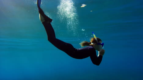 snorkeling girl underwater