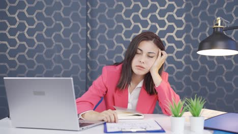 Tired-young-business-woman-falling-asleep-at-laptop.