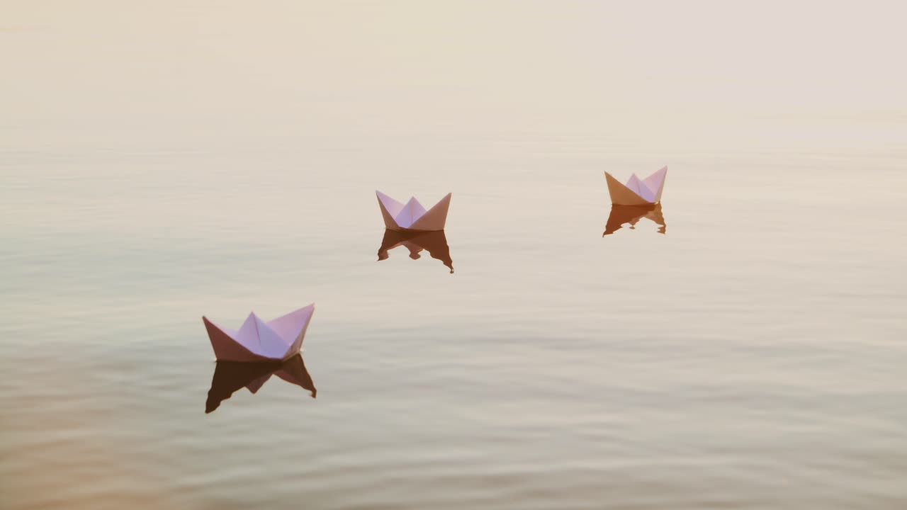 Three white paper ships floating in the river at sunset. Small childish paper boats swim in the lake with their reflection in the calm water.