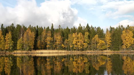 Spectacular-autumn-color-reflection-on-still-water-in-moving-shot