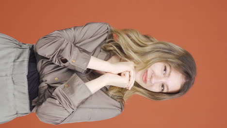 vertical video of young woman clapping excitedly to camera.