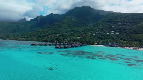 sofitel kia ora resort moorea toatea lookout french polynesia aerial drone snorkel swim turquoise bungalow blue water coral reef blue sky cloud layer mtns tema'e public beach beach forward pan up