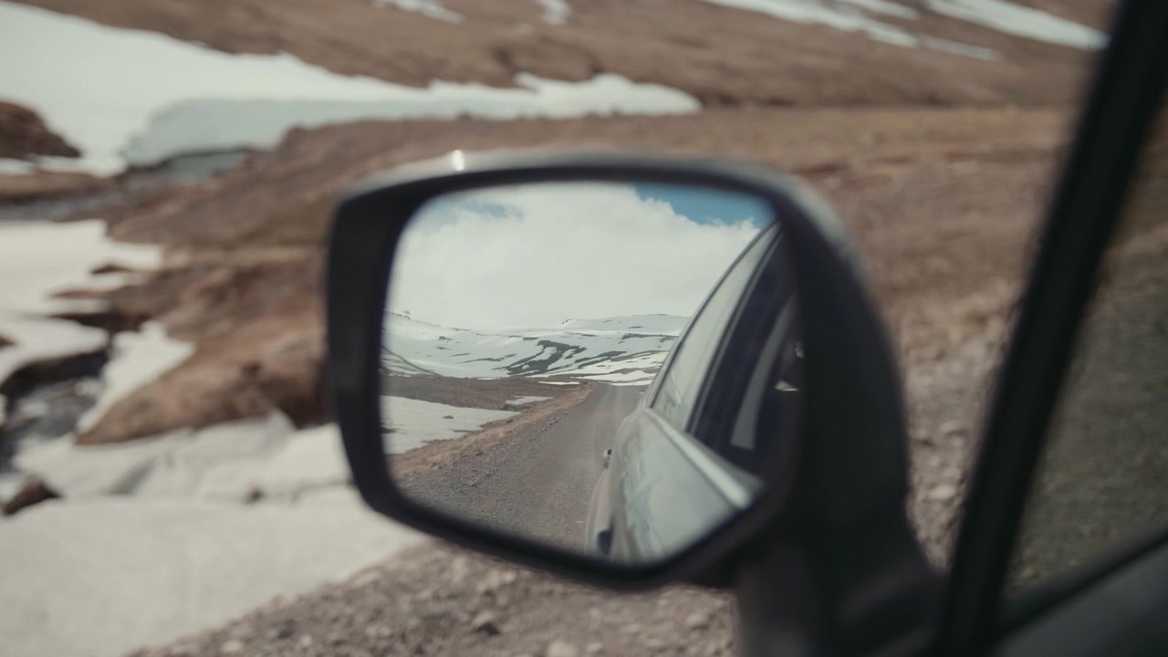 Scenic Mountain Road Reflected in Car Side Mirror