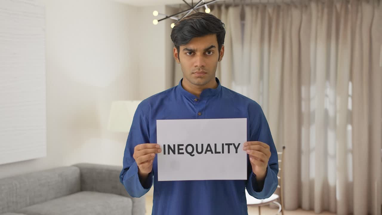 niño indio enojado sosteniendo una pancarta de desigualdad
