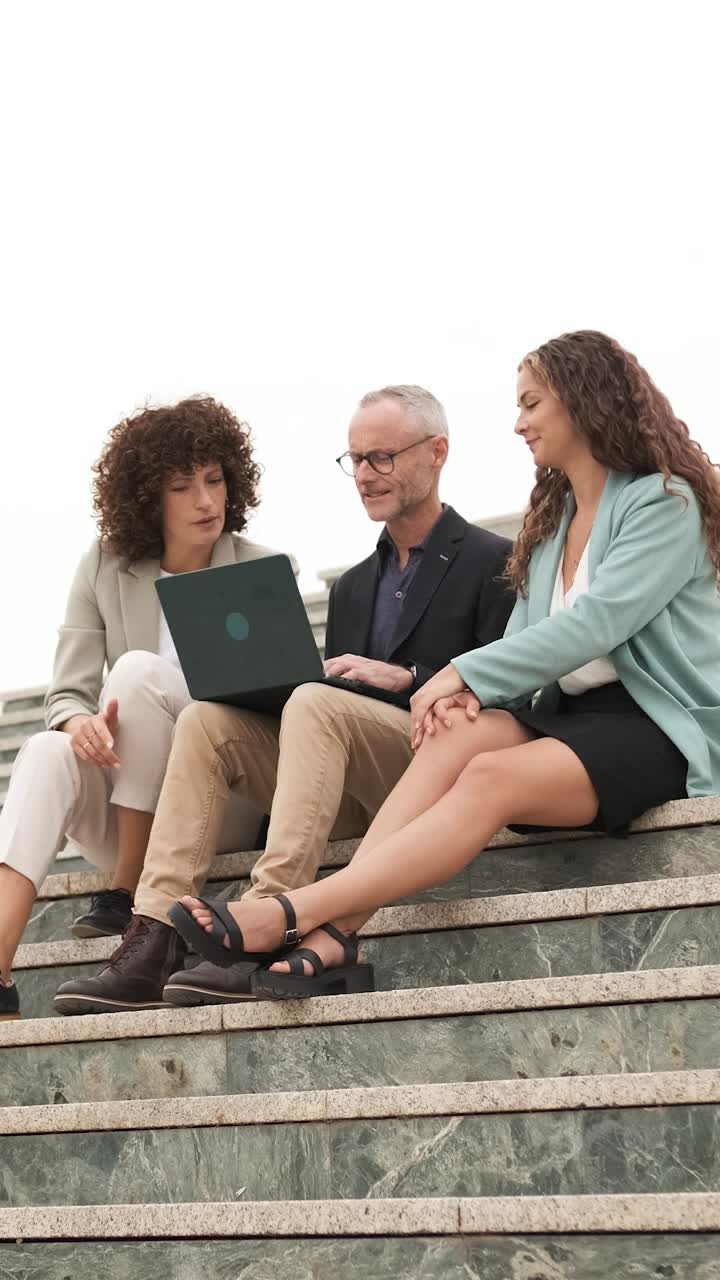 Business people having meeting on stairs. Vertical