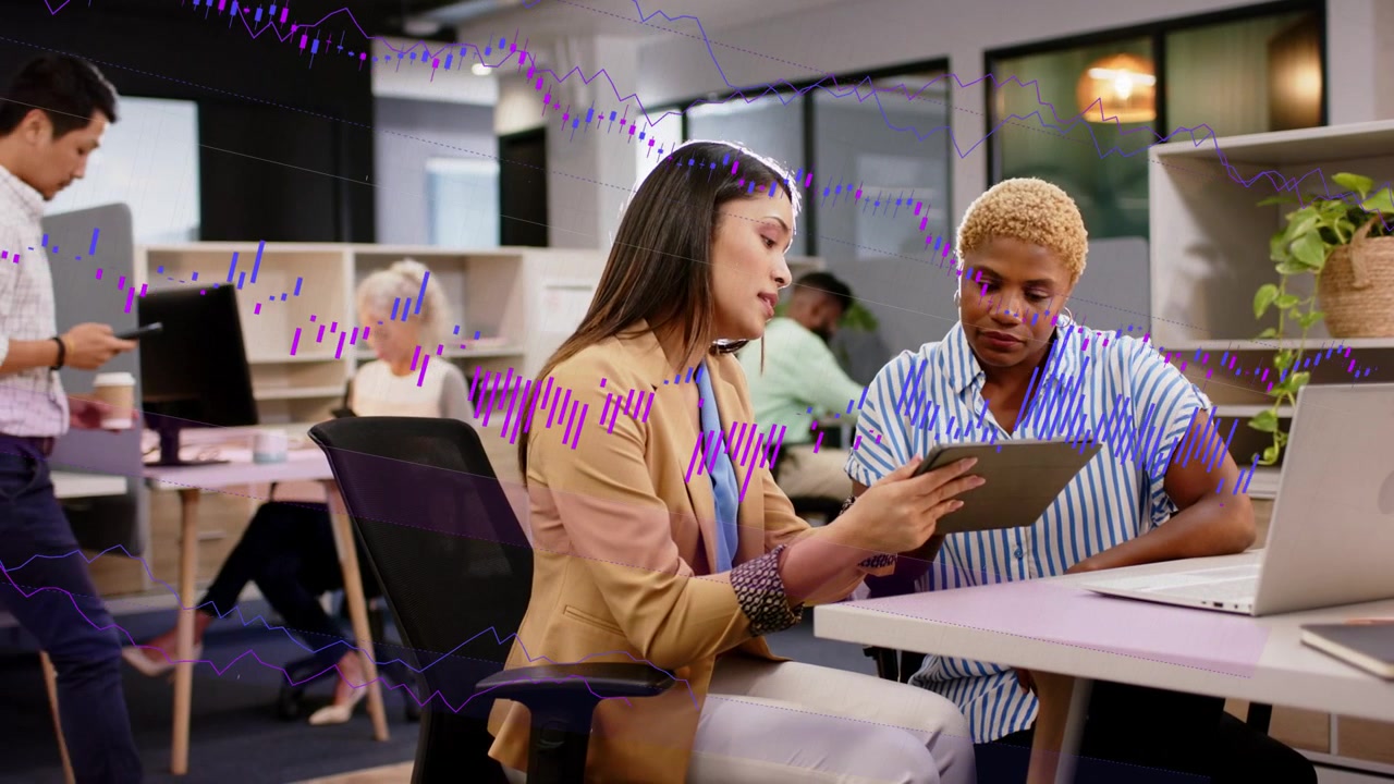 Woman pointing tablet and causing purple wave overlay rising while peer leaning, reviewing business