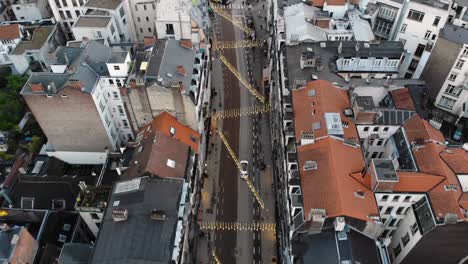 aerial forwarding flight while drone is following white car in brussels' streets, belgium