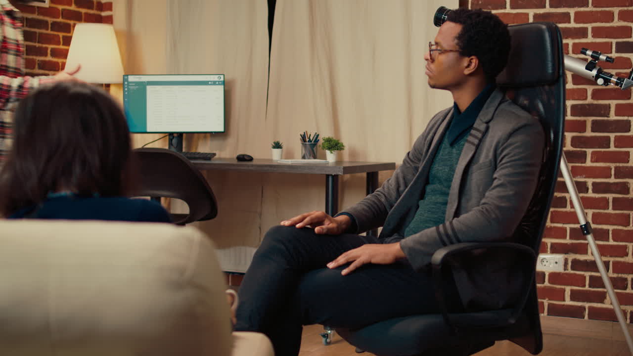 African american specialist listening to man and woman with marriage problems