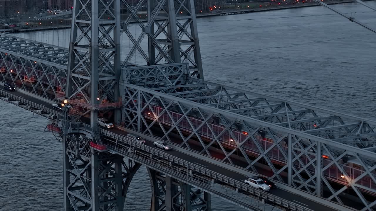 Williamsburg Bridge steel towers and traffic at dusk