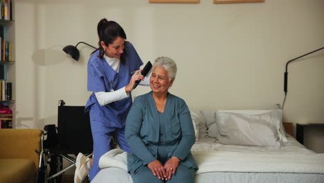 a nurse combing an elderly woman's hair in a bedroom