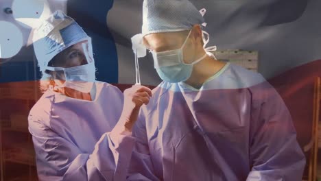 Animation-of-flag-of-chile-waving-over-surgeons-in-face-masks