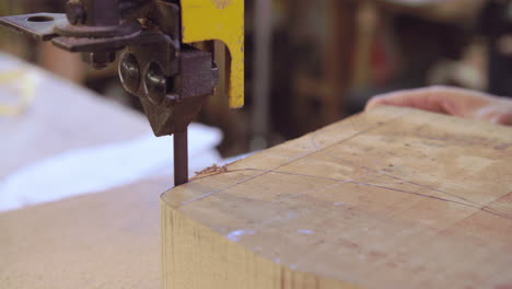 bespoke shoemaker cutting wooden last for shoe using jigsaw