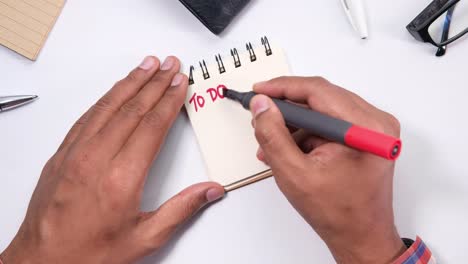 person writing a to-do list