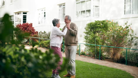 elderly couple dancing in the garden