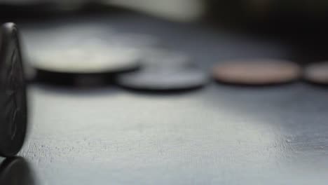close-up of coins on a dark surface