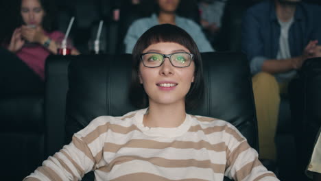 woman enjoying a movie at the cinema