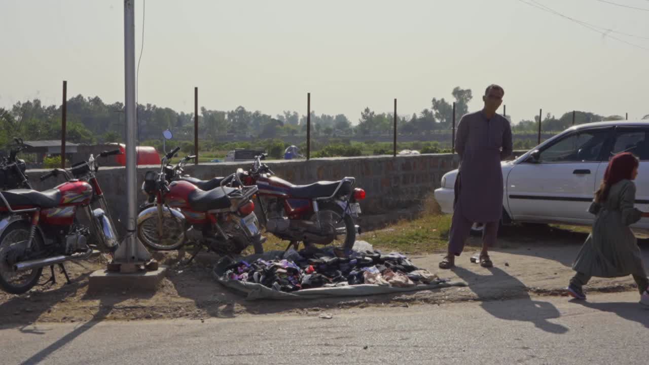 Family and People Walking on a Busy Street in Pakistan