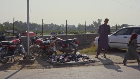 family and people walking on a busy street in pakistan