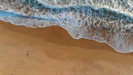 waves crashing on a beach in the portuguese shore