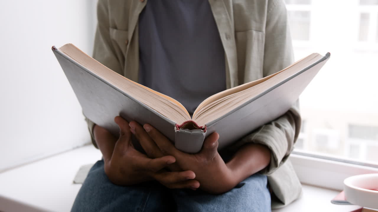 Person Reading a Book Indoors