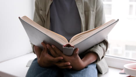 person reading a book indoors