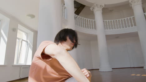 focused young man in casual wear performing a contemporary dance in the studio 2