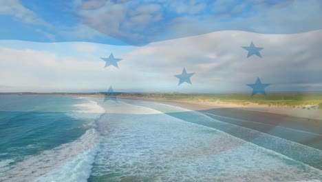 Digital-composition-of-waving-honduras-flag-against-aerial-view-of-the-beach-and-sea-waves