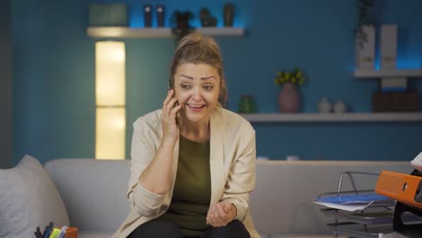 home office worker woman rejoicing on the phone.