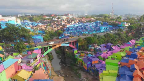 Flying-over-jodipan-rainbow-village-at-Malang-Indonesia,-aerial