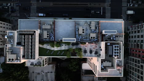 aerial view above the roof of a modern condo, sunset in brooklyn, ny, usa - top down, drone shot