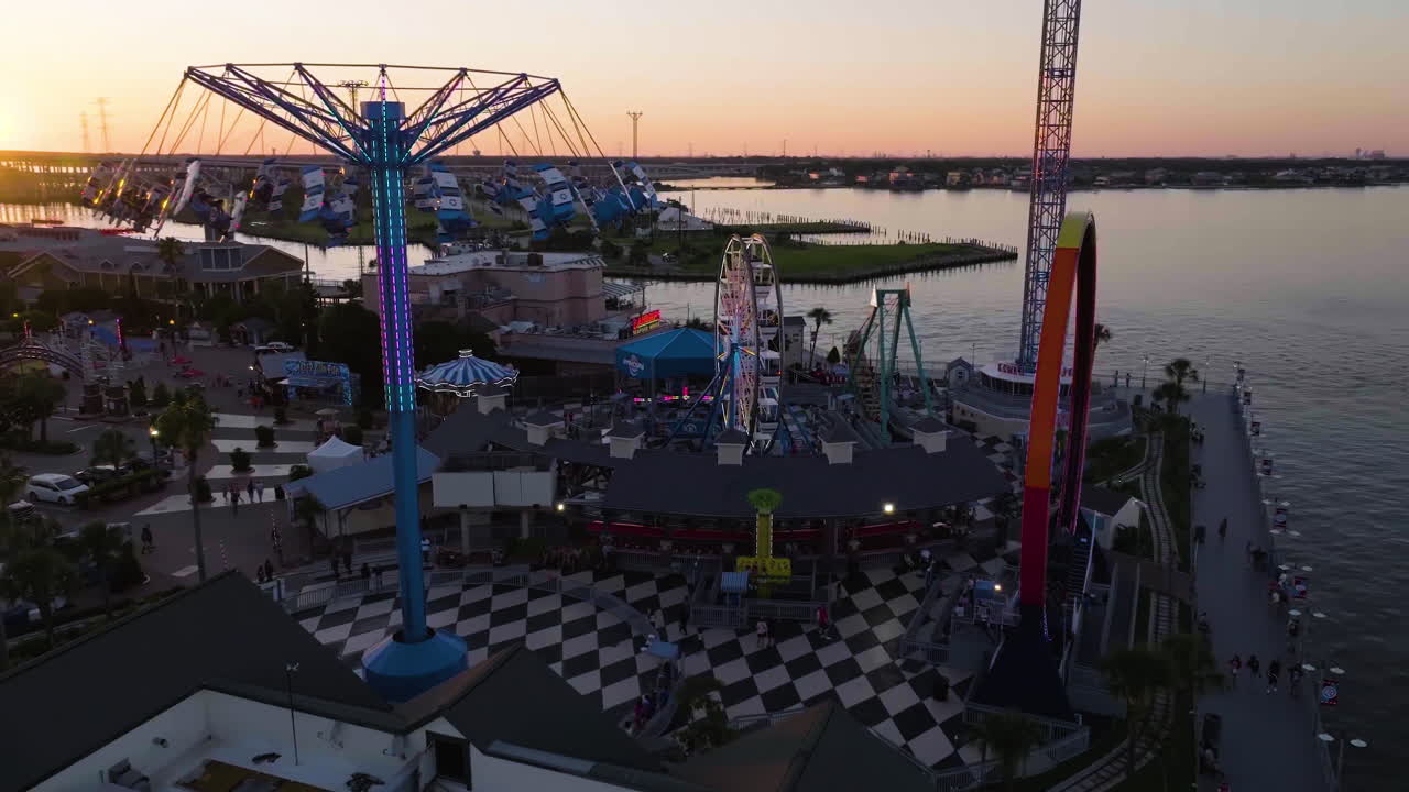 Drone circling rides at the Kemah Boardwalk park, colorful sunset in Texas, USA