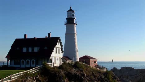 the portland head lighthouse oversees the ocean from rocks in maine new england  4