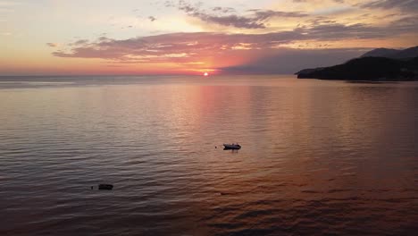 Aerial-sunset-on-the-sea,-breathtaking-view-of-the-sun-setting-over-the-ocean