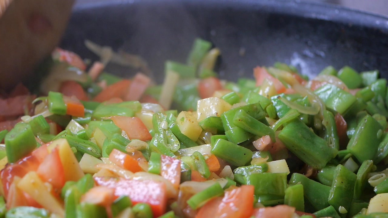 Stirring Fresh Chopped Vegetables in a Hot Pan
