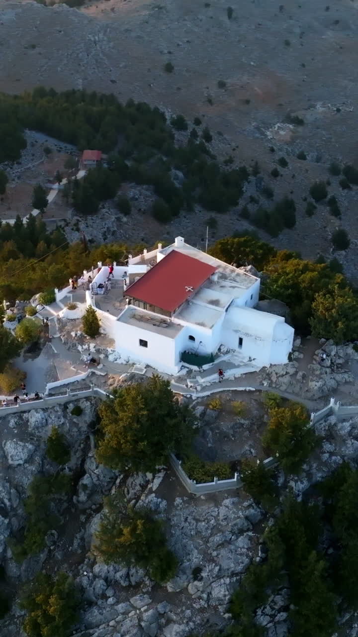 Vertical drone shot orbiting the Holy Monastery of Virgin Mary Tsambika in Rhodes